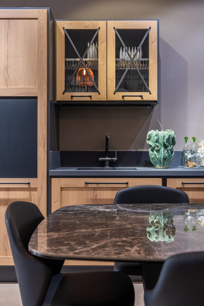 Elegant kitchen with wooden cabinets and marble tabletop, perfect for contemporary homes.
